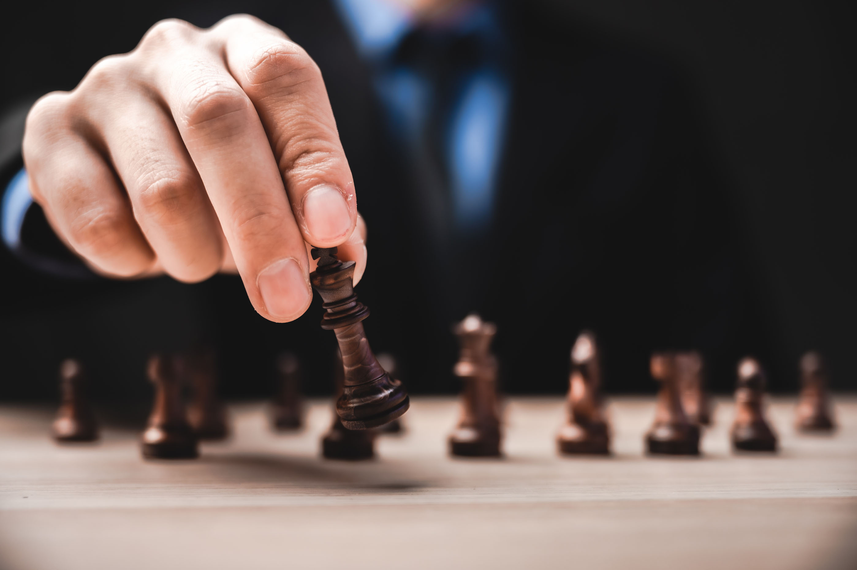 idea of winner, business leadership and successful concept with chess pieces and businessman hand